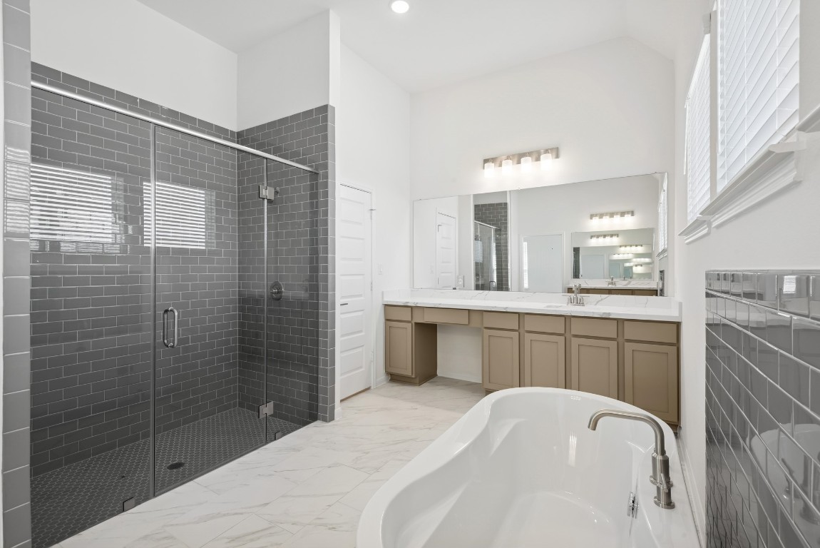 5033 Bluebell Way Waller, TX 77484 - Photo 13 of 23 a bathroom with a bathtub shower sink vanity granite and toilet