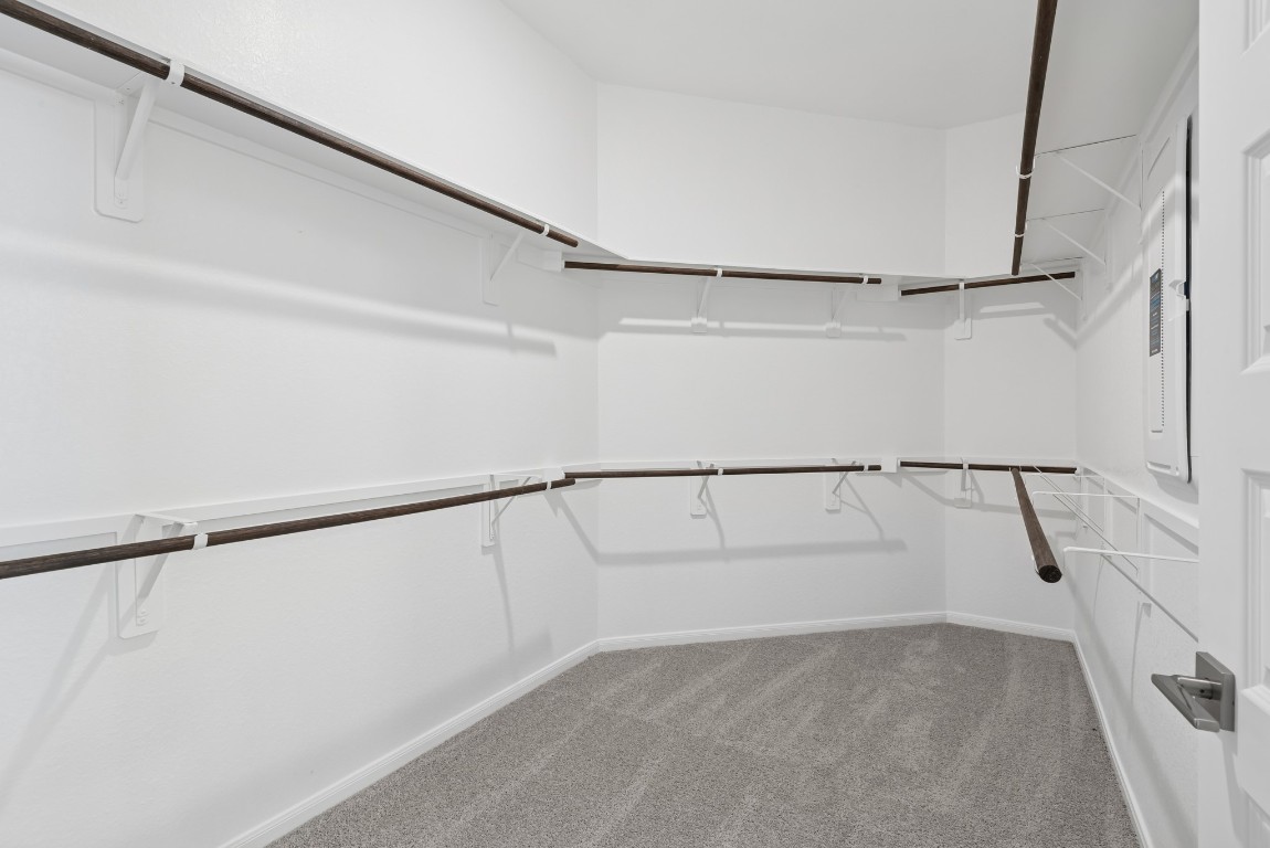 5033 Bluebell Way Waller, TX 77484 - Photo 15 of 23 a view of walk in closet with empty racks