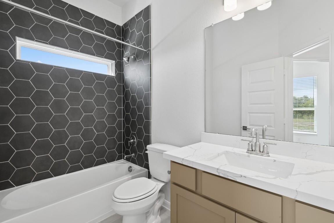 5033 Bluebell Way Waller, TX 77484 - Photo 20 of 23 a bathroom with a granite countertop bathtub shower sink vanity mirror and toilet