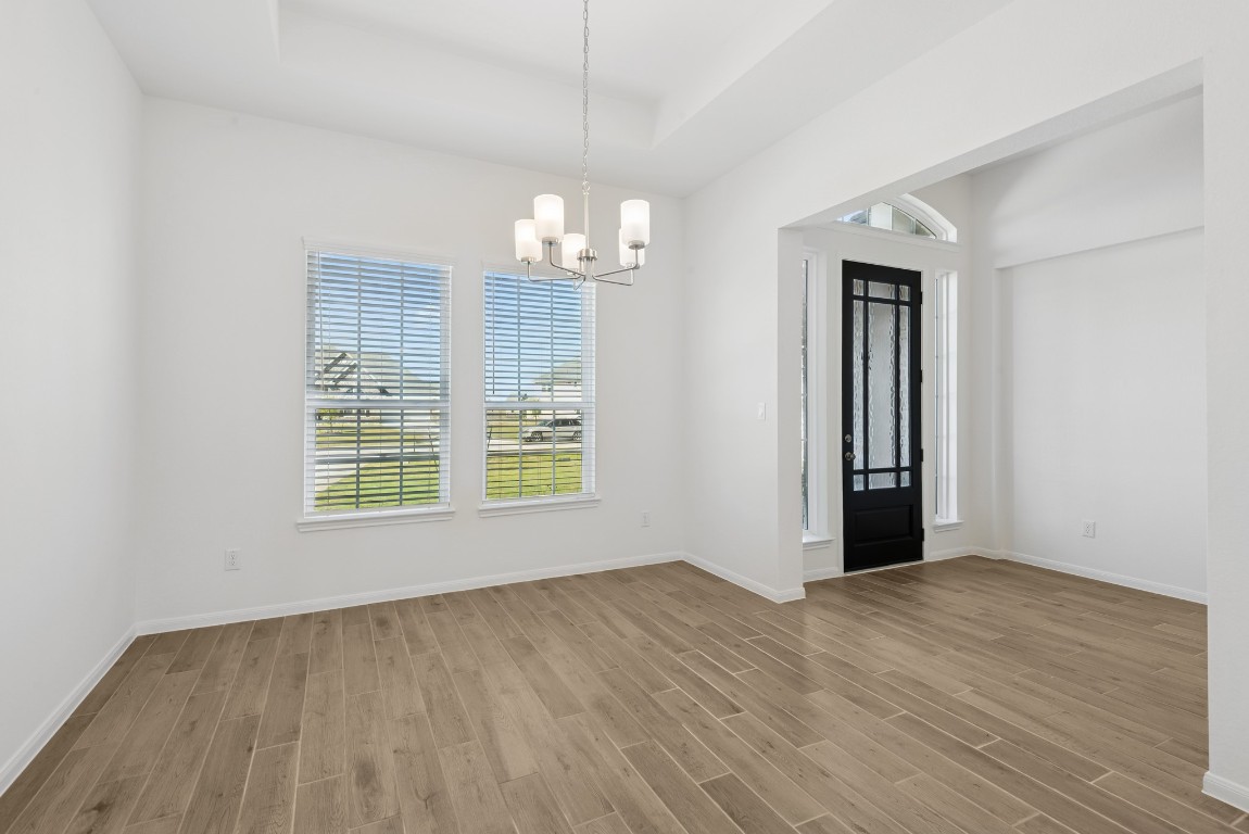 5033 Bluebell Way Waller, TX 77484 - Photo 4 of 23 a view of an empty room with wooden floor and a window