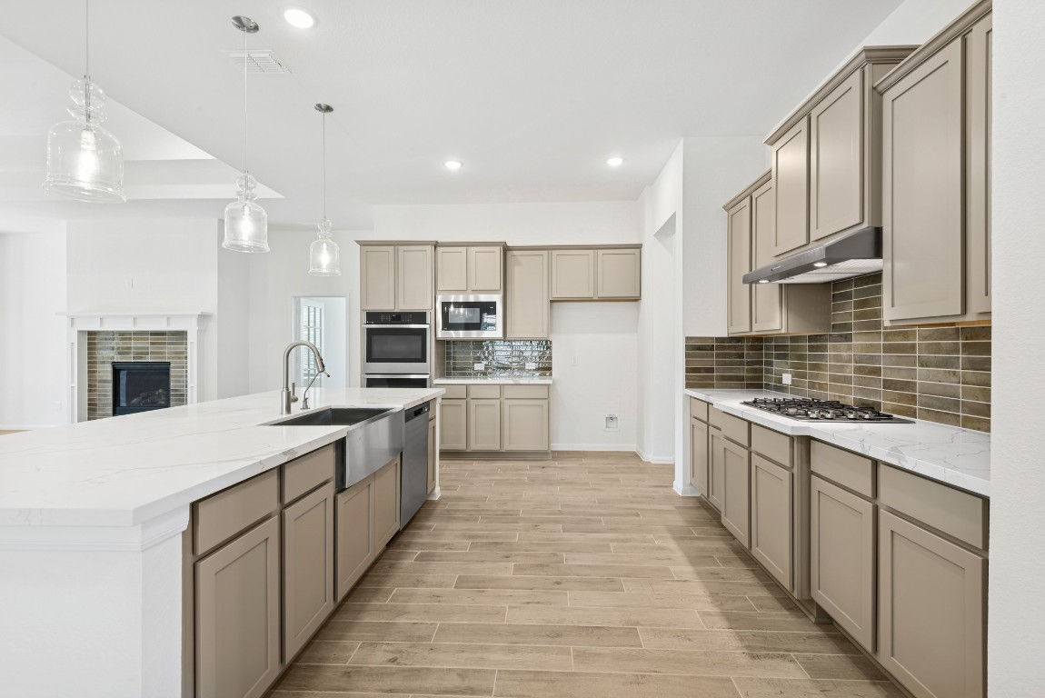 5033 Bluebell Way Waller, TX 77484 - Photo 6 of 23 a open kitchen with stainless steel appliances granite countertop a stove top oven a sink dishwasher and a refrigerator