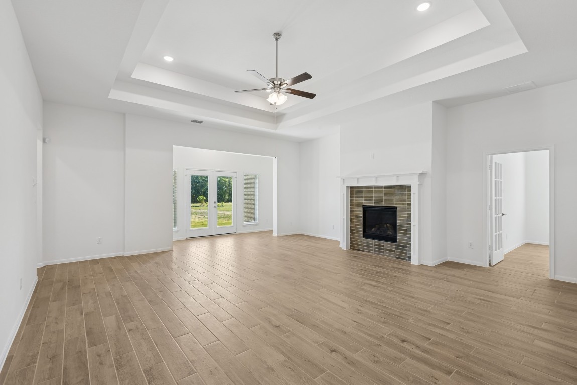 5033 Bluebell Way Waller, TX 77484 - Photo 8 of 23 a view of empty room with wooden floor fireplace and window