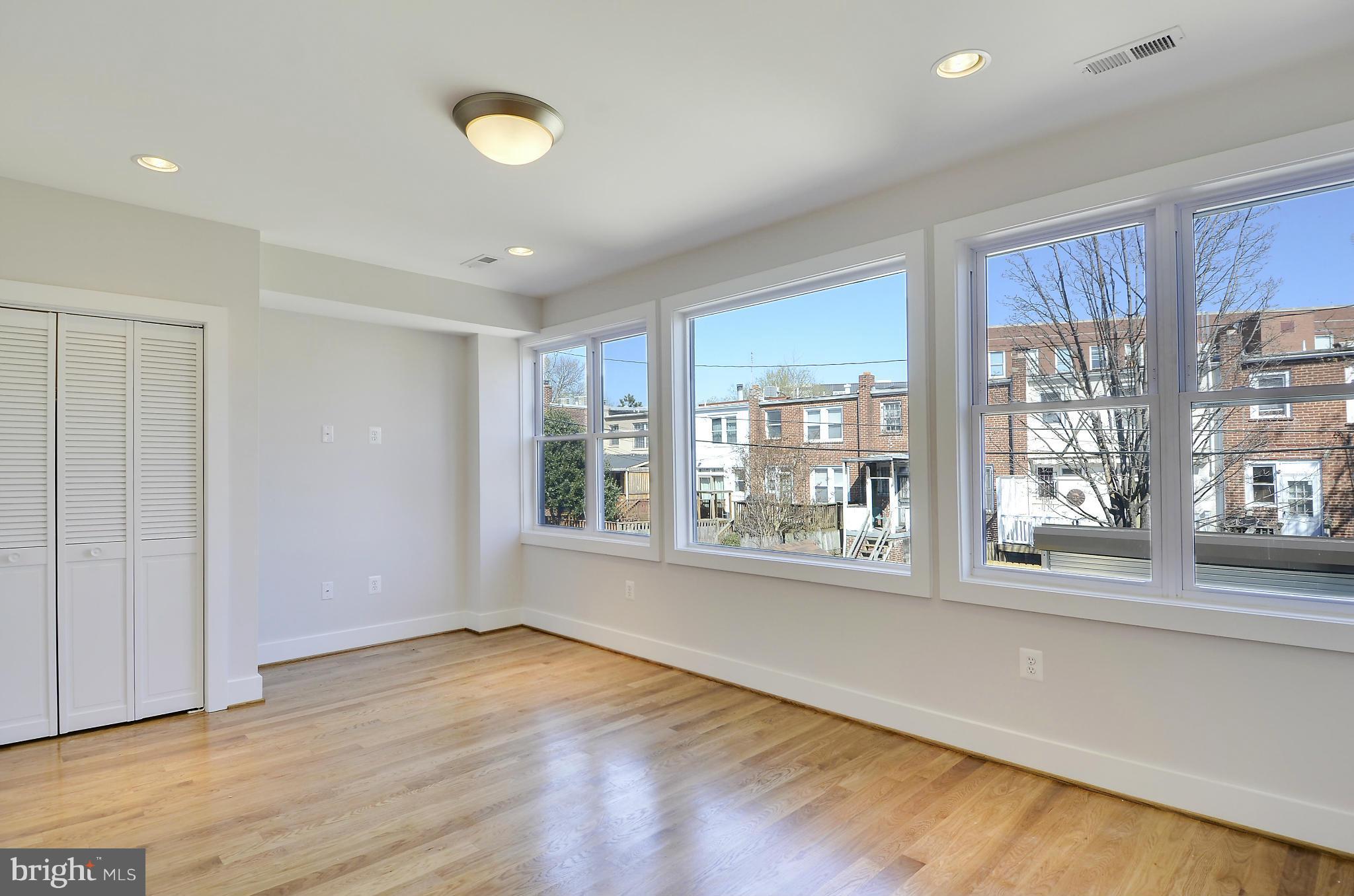 1350 K Street Southeast Washington, DC 20003 - Photo 12 of 28 a view of an empty room with a window and wooden floor