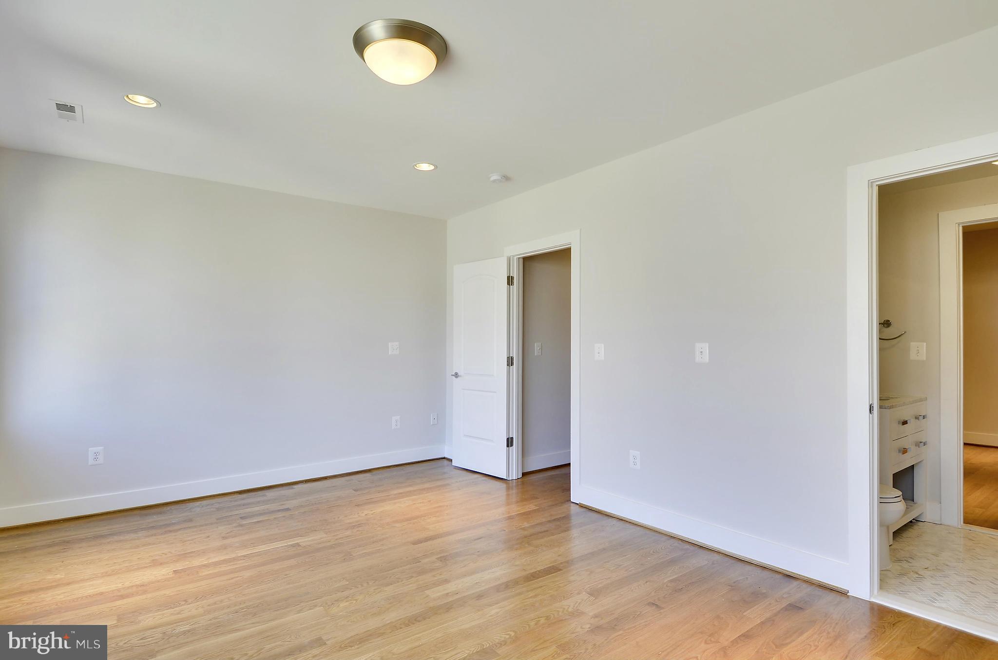 1350 K Street Southeast Washington, DC 20003 - Photo 16 of 28 an empty room with wooden floor and windows