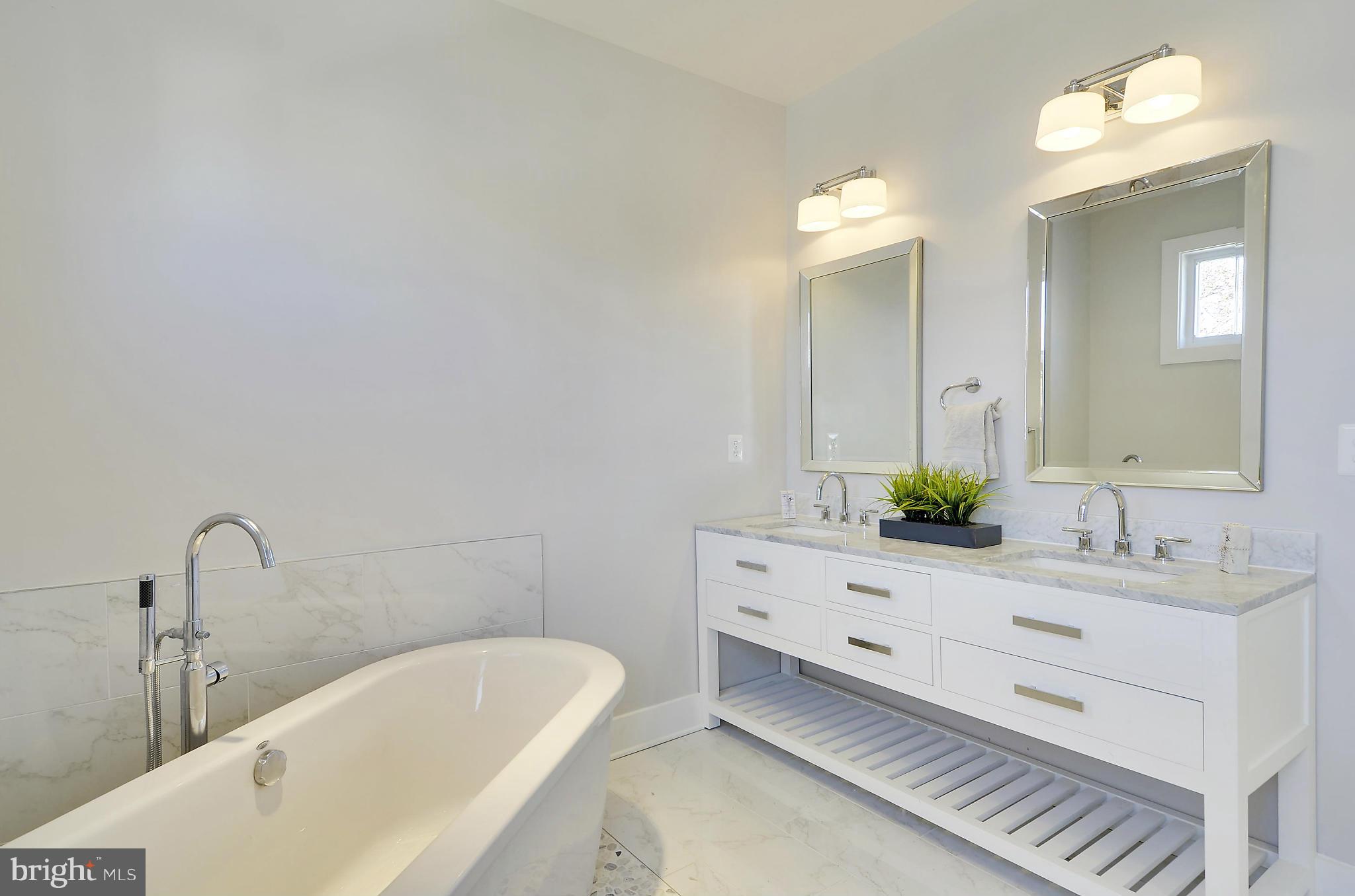 1350 K Street Southeast Washington, DC 20003 - Photo 20 of 28 a bathroom with a bathtub sink and mirror