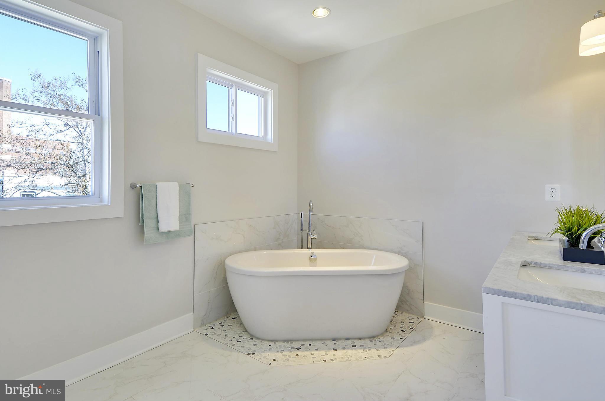 1350 K Street Southeast Washington, DC 20003 - Photo 21 of 28 a white bath tub sitting in a bathroom