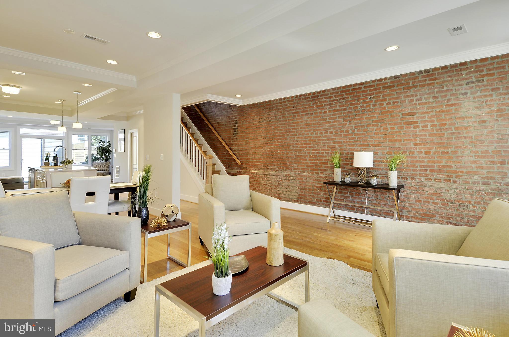 1350 K Street Southeast Washington, DC 20003 - Photo 4 of 28 a living room with couches and kitchen view with wooden floor