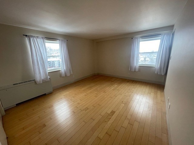 1600 Beacon Street, Unit 1012 Brookline, MA 02446 - Photo 20 of 27 a view of an empty room with wooden floor and a window