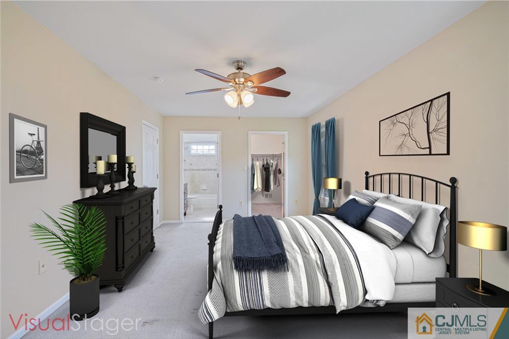18 Main Street Helmetta, NJ 08828 - Photo 14 of 32 a spacious bedroom with a bed and a chandelier