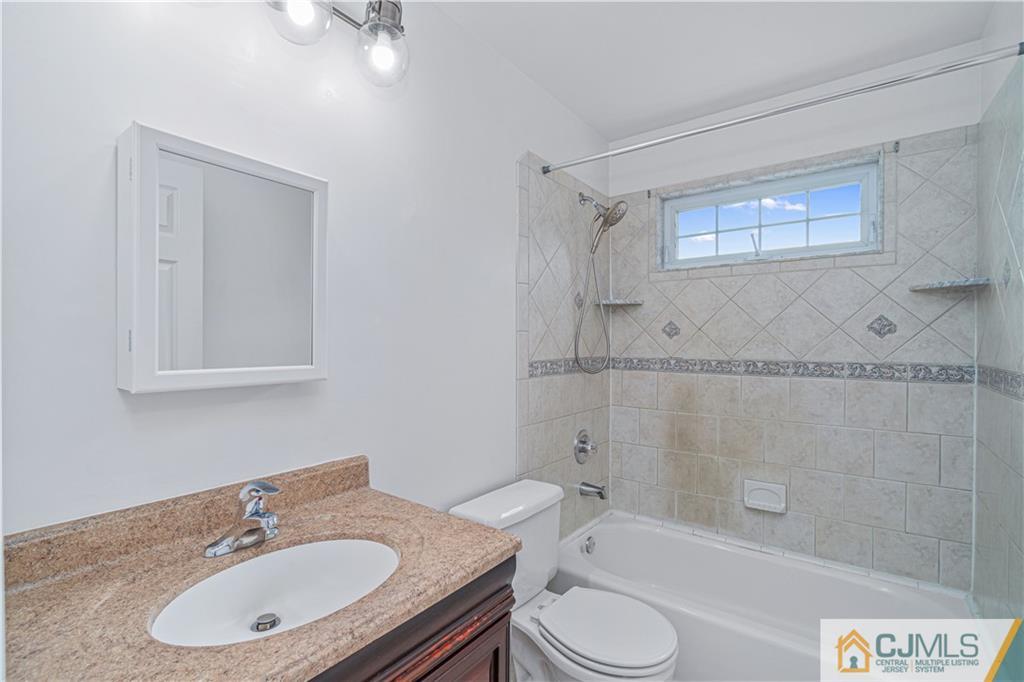 18 Main Street Helmetta, NJ 08828 - Photo 18 of 32 a bathroom with a granite countertop sink toilet a mirror and shower