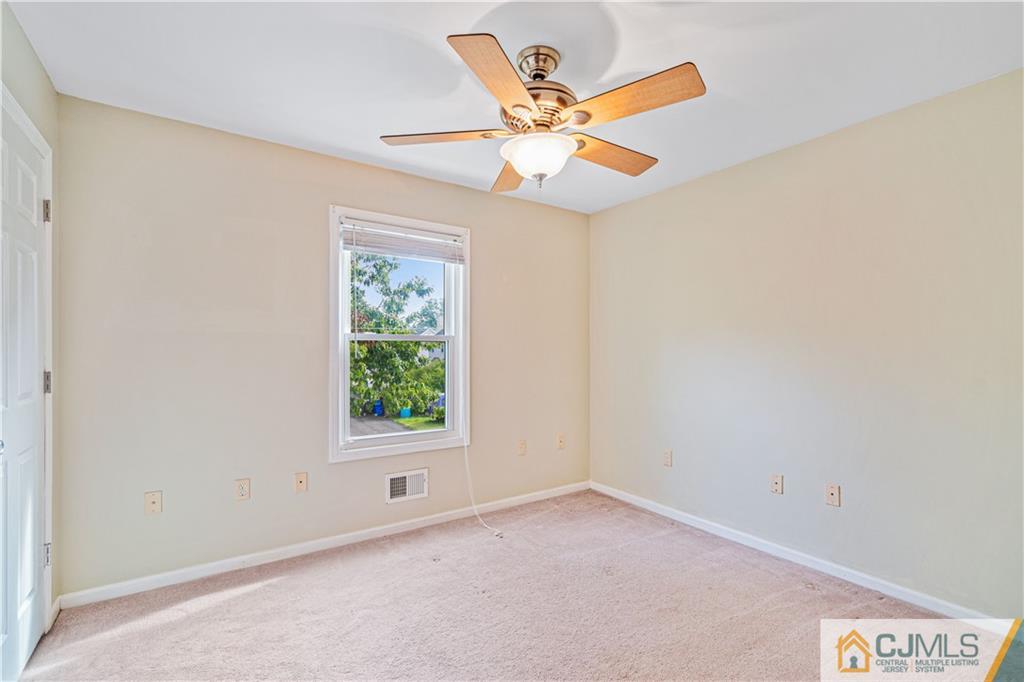 18 Main Street Helmetta, NJ 08828 - Photo 20 of 32 an empty room with a window and a fan