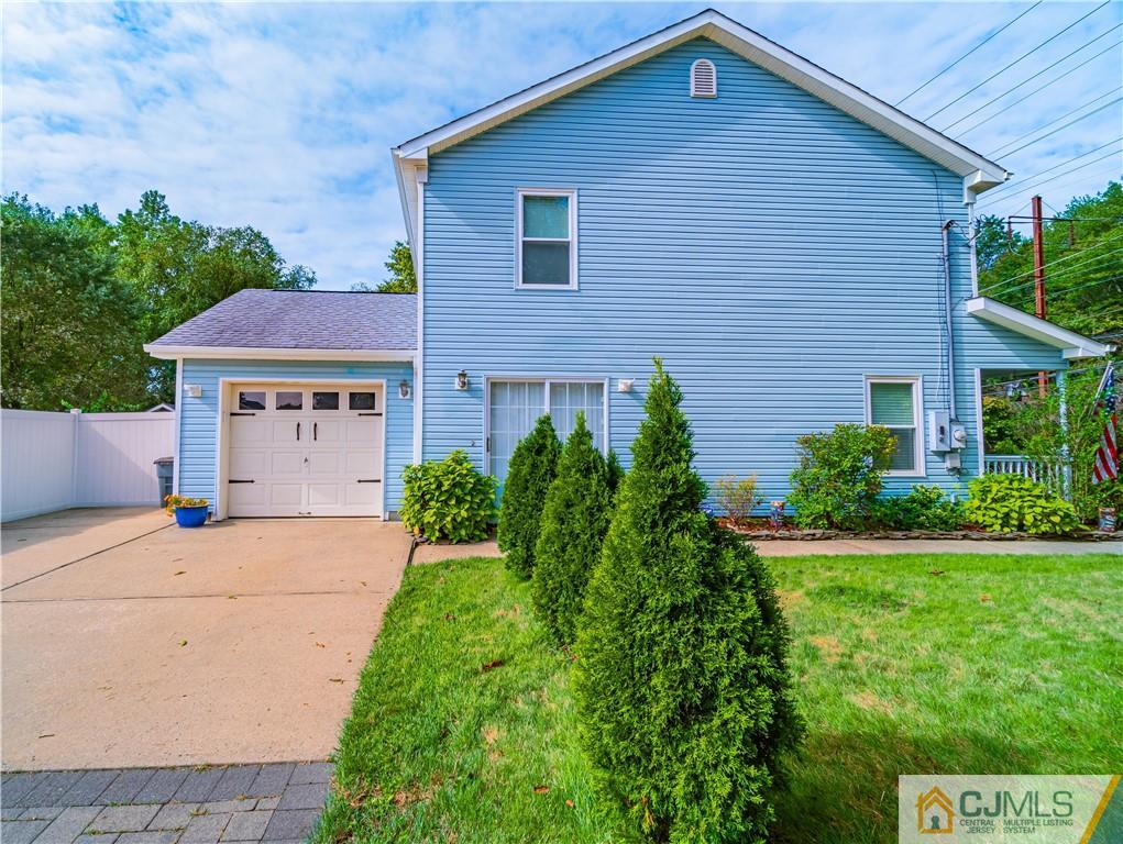 18 Main Street Helmetta, NJ 08828 - Photo 23 of 32 a front view of a house with a yard and garage