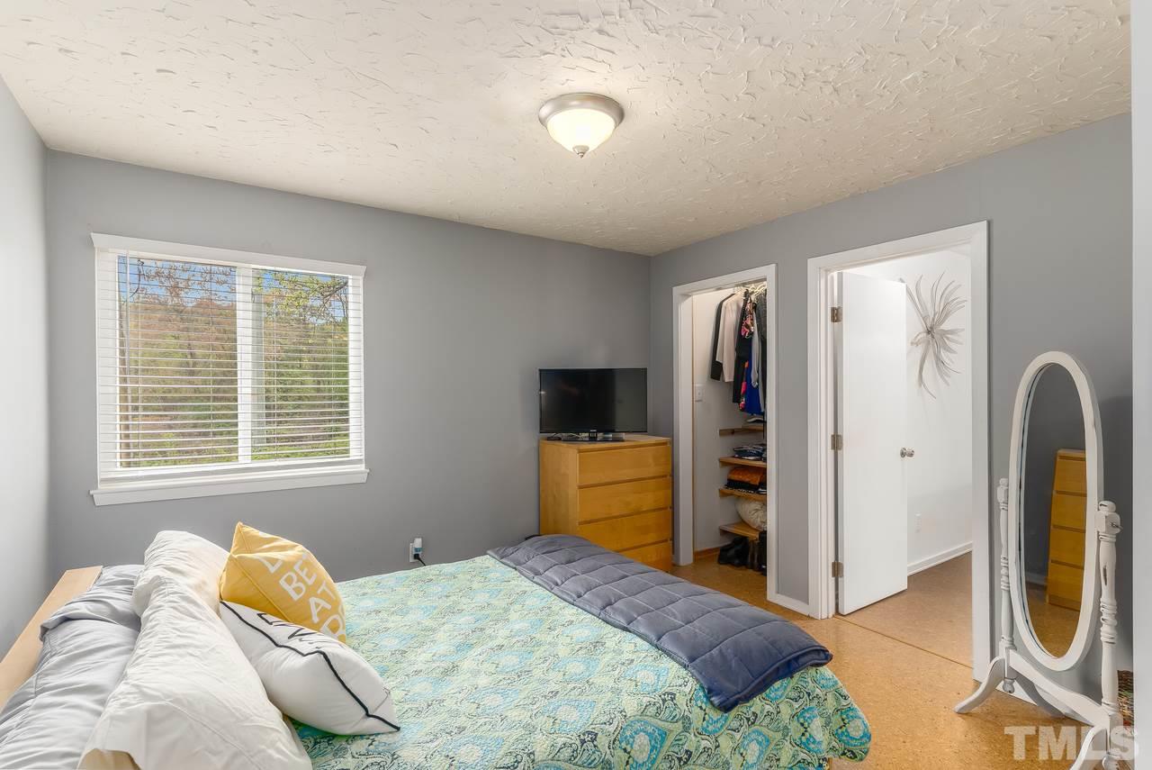 728 Godwin Court Raleigh, NC 27606 - Photo 14 of 25 a bedroom with a bed and a television