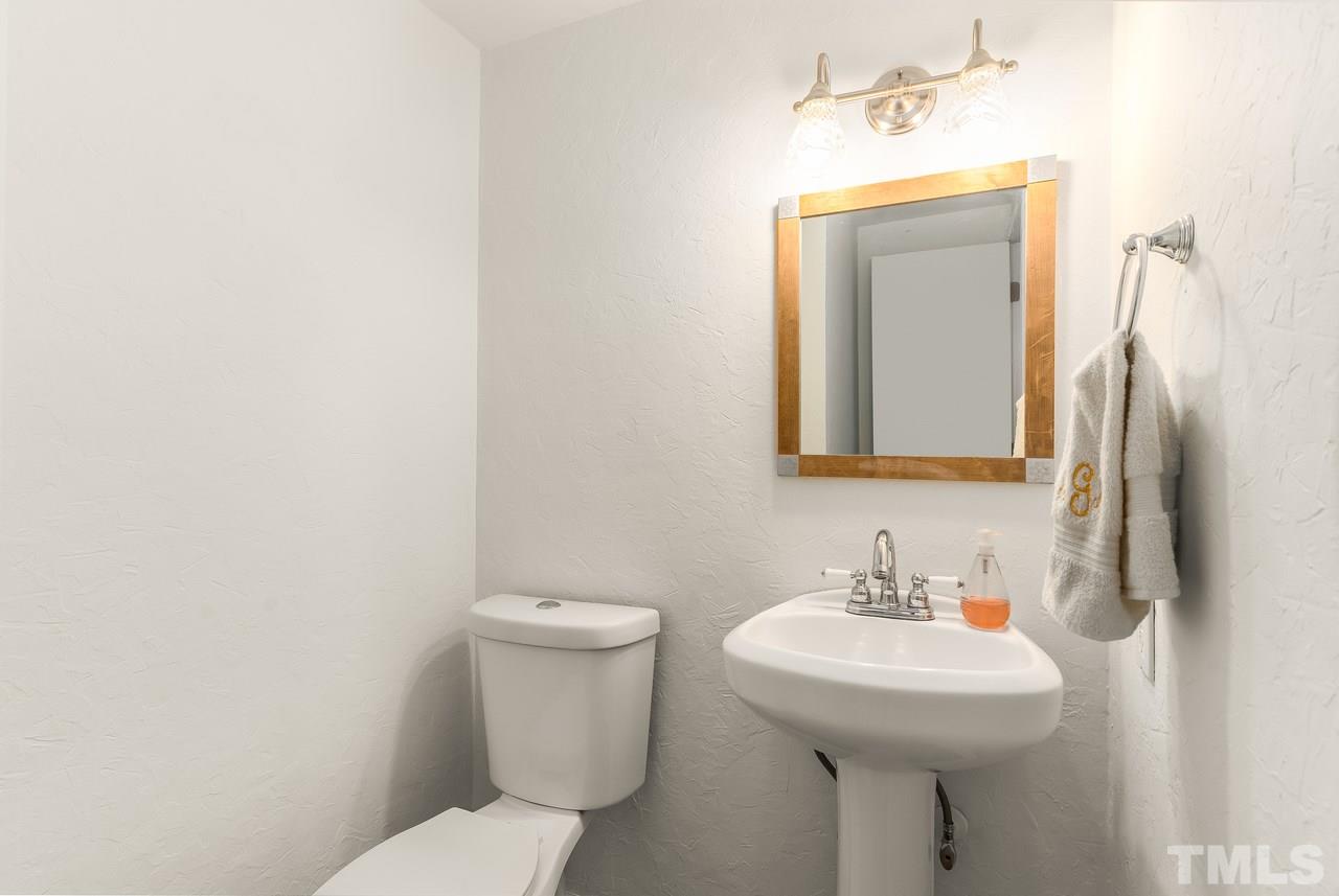 728 Godwin Court Raleigh, NC 27606 - Photo 22 of 25 a bathroom with a toilet sink and mirror