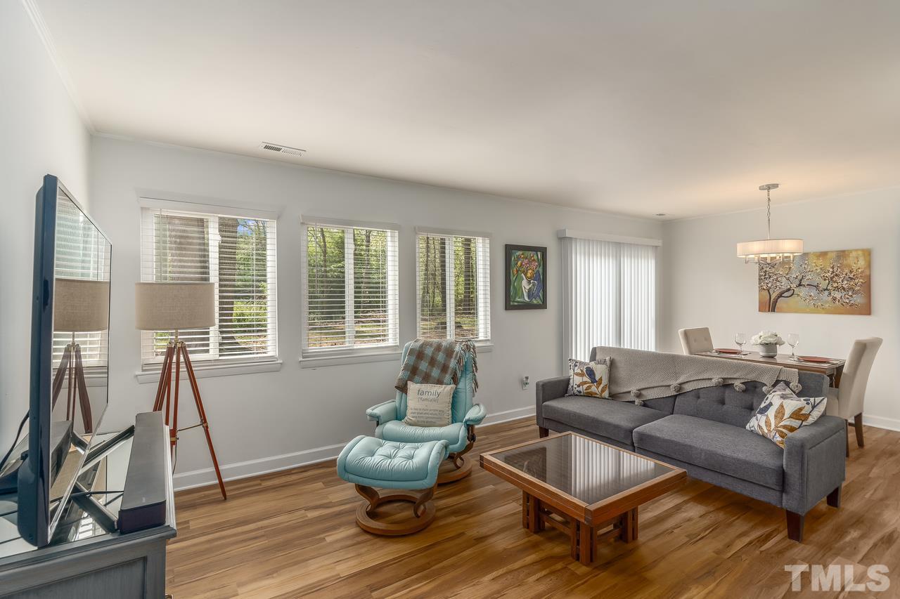 728 Godwin Court Raleigh, NC 27606 - Photo 6 of 25 a living room with furniture and a floor to ceiling window
