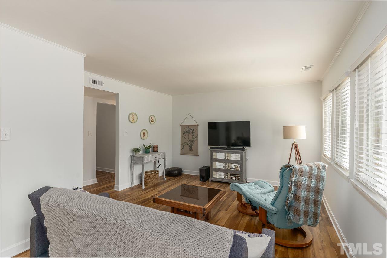 728 Godwin Court Raleigh, NC 27606 - Photo 7 of 25 a living room with furniture and a flat screen tv