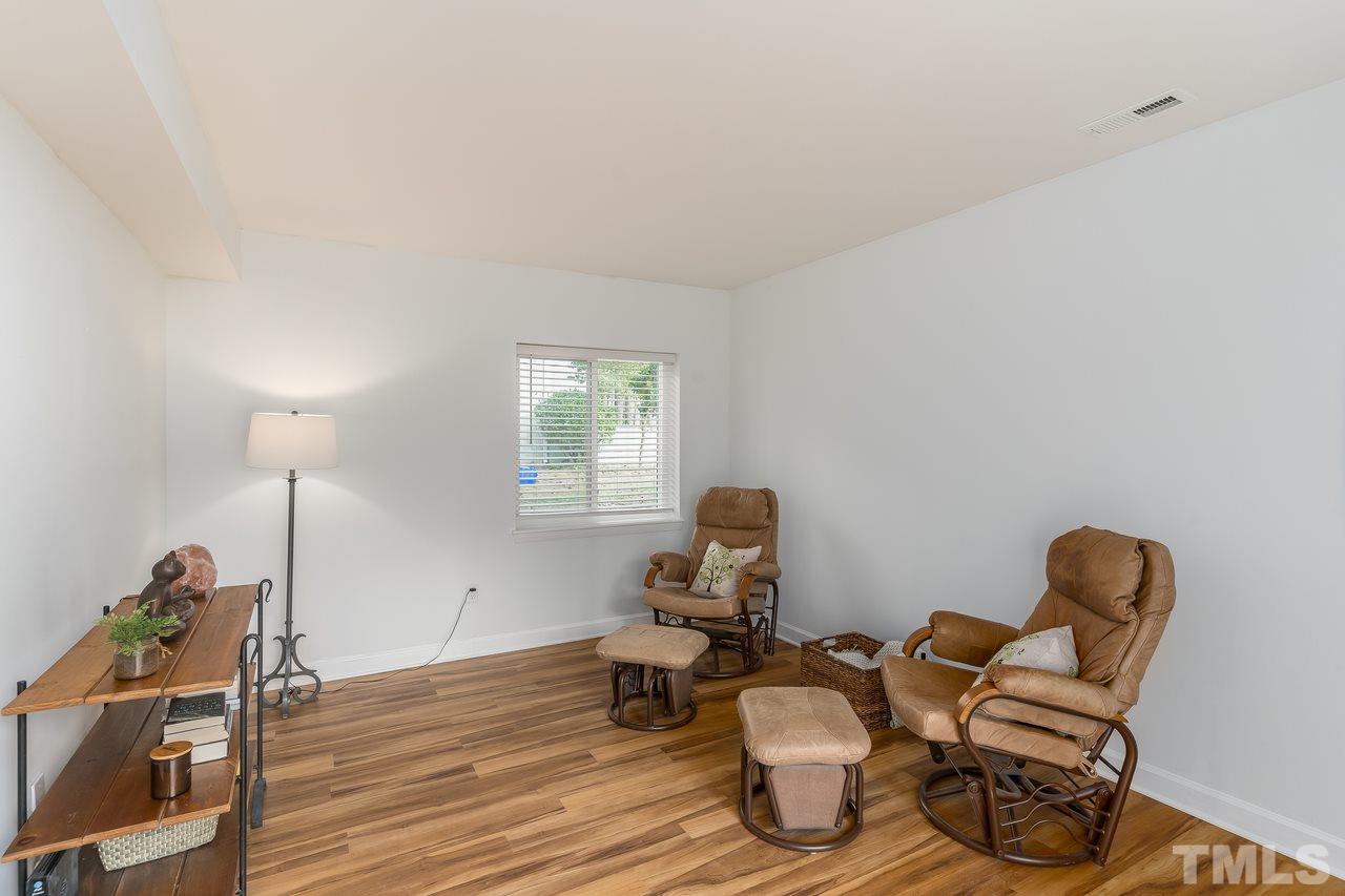 728 Godwin Court Raleigh, NC 27606 - Photo 10 of 25 a living room with furniture and a wooden floor