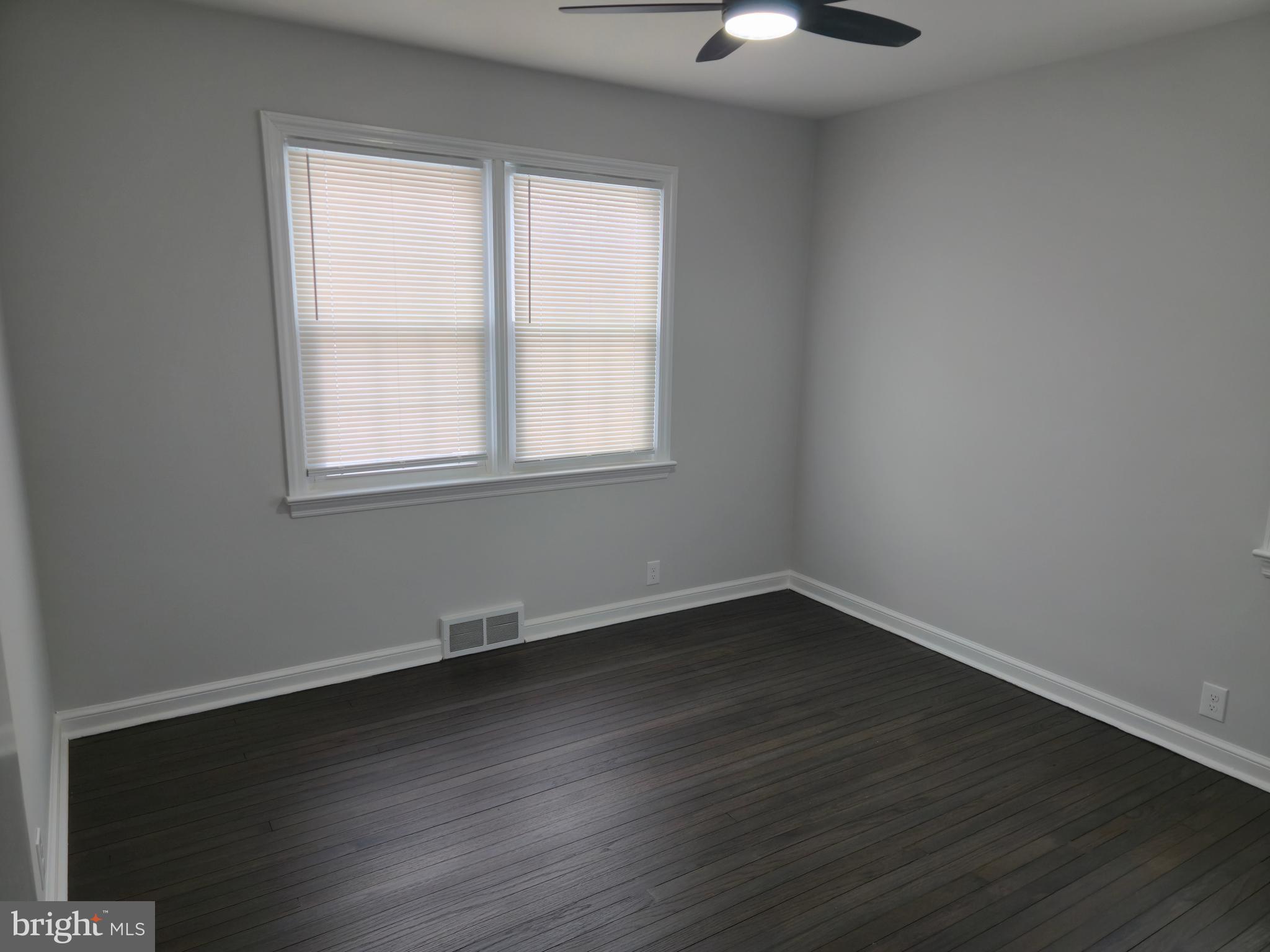 212 New Albany Road Moorestown, NJ 08057 - Photo 13 of 26 an empty room with wooden floor and windows
