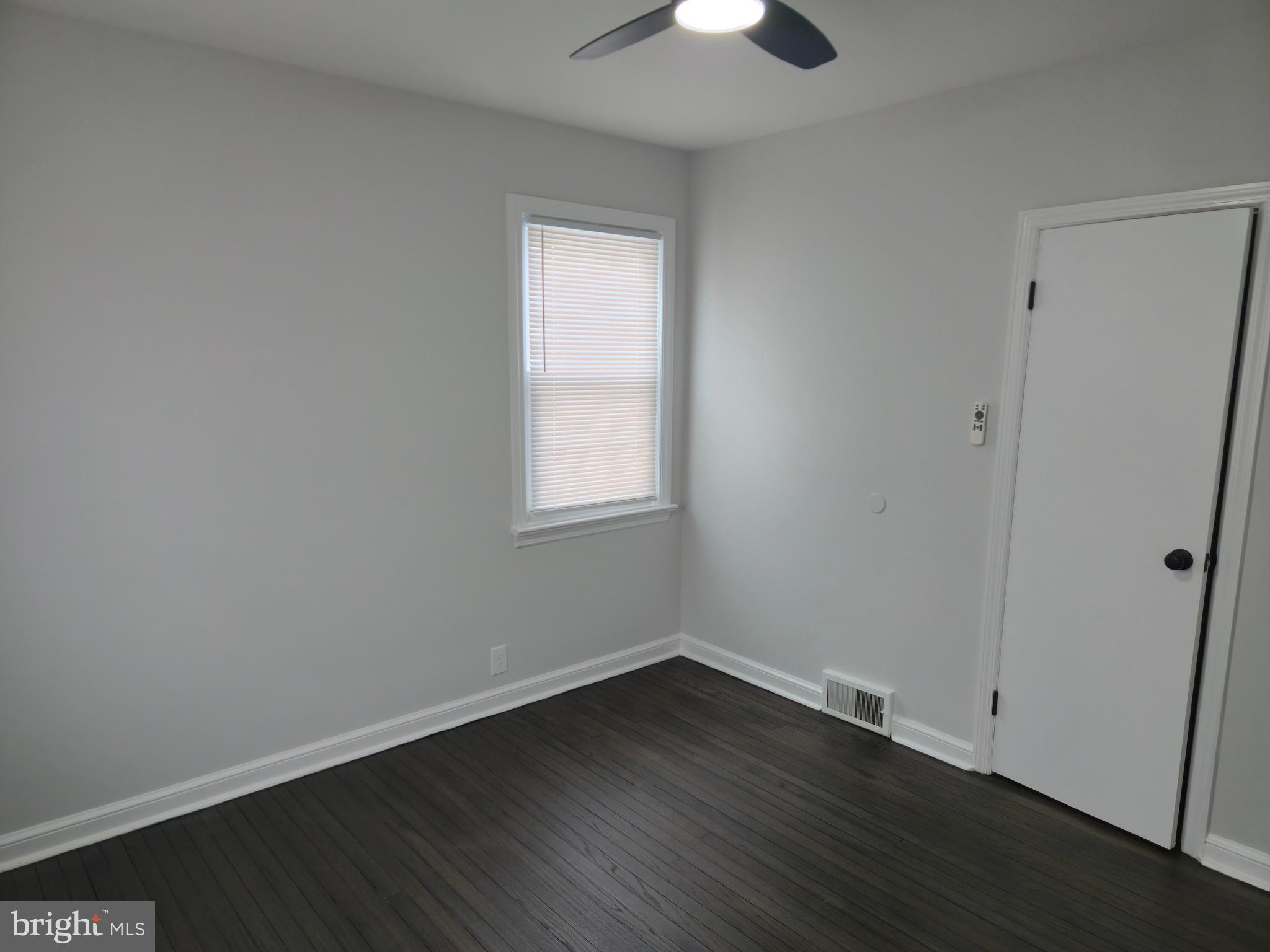 212 New Albany Road Moorestown, NJ 08057 - Photo 14 of 26 an empty room with wooden floor and windows