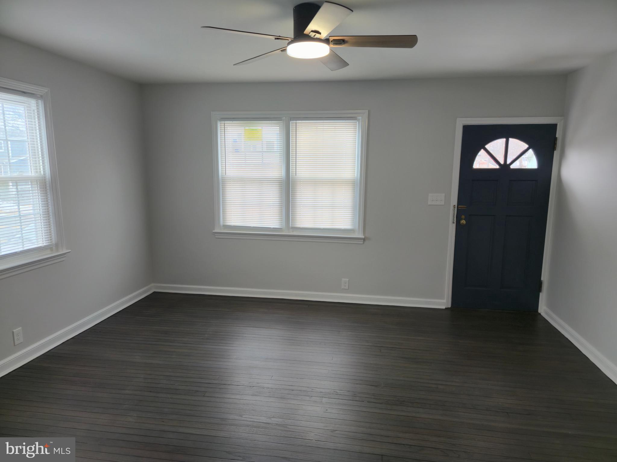 212 New Albany Road Moorestown, NJ 08057 - Photo 2 of 26 an empty room with wooden floor fan and windows
