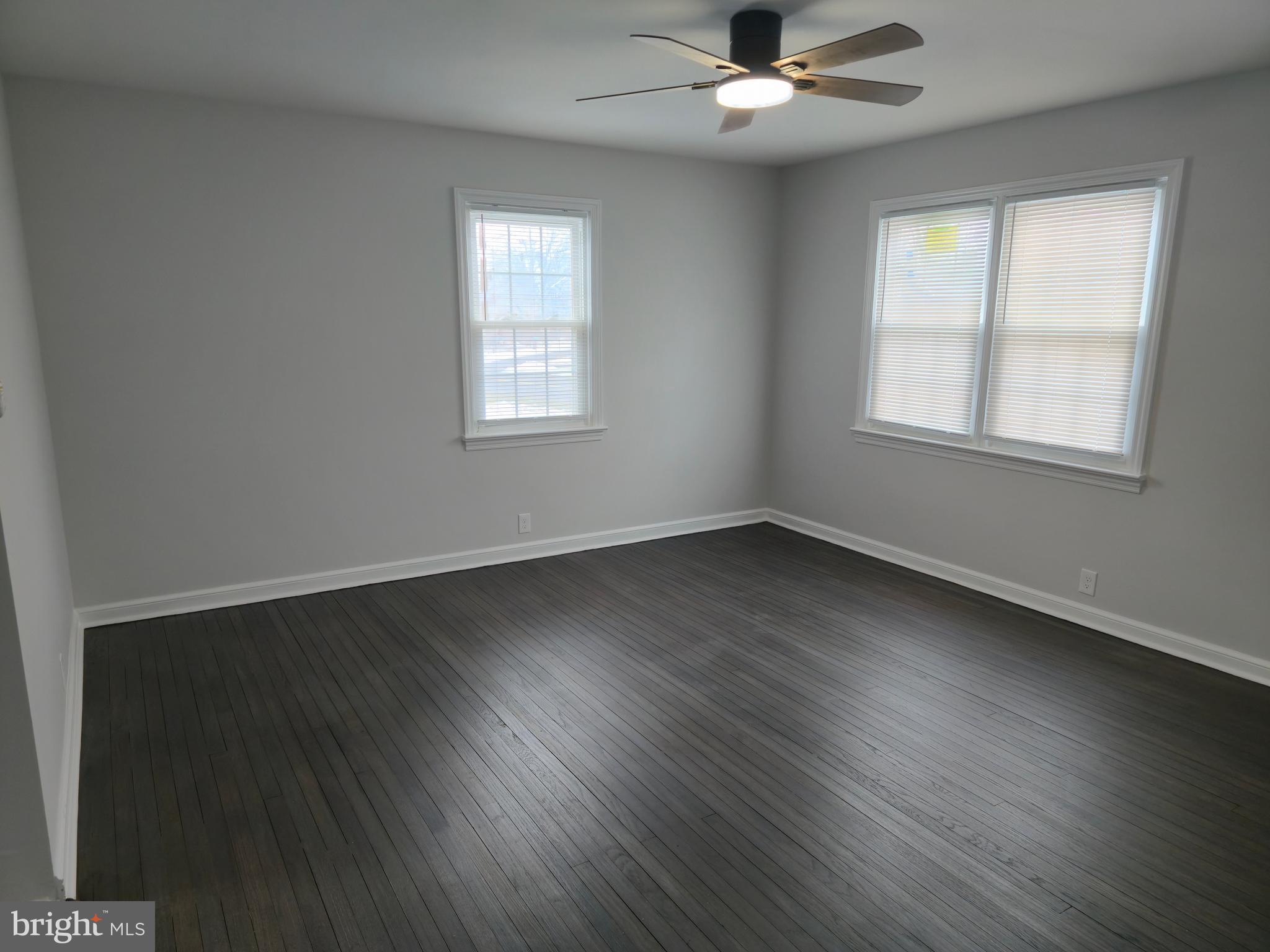 212 New Albany Road Moorestown, NJ 08057 - Photo 3 of 26 a view of an empty room with wooden floor and a window