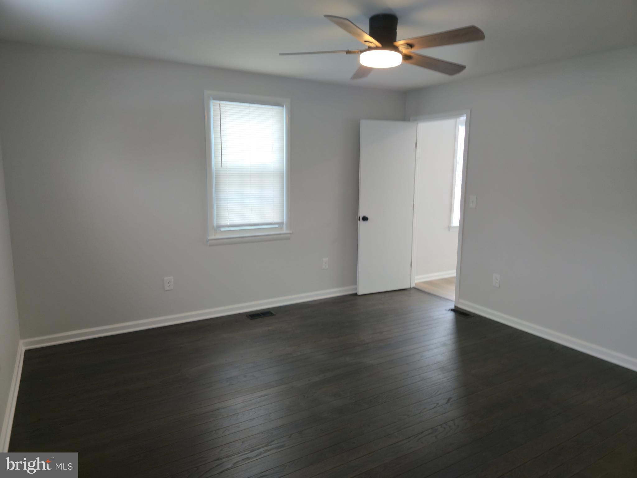 212 New Albany Road Moorestown, NJ 08057 - Photo 10 of 26 a view of an empty room with wooden floor and a window