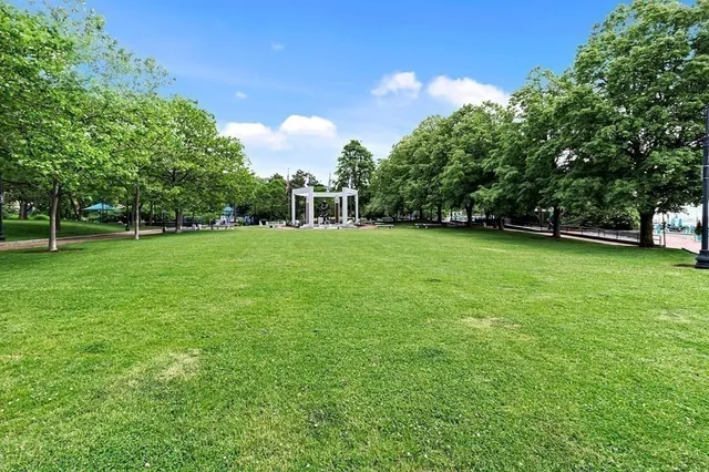 a view of a big yard with a house in the background