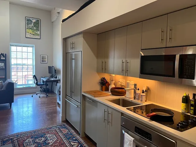 a kitchen with a sink cabinets and stainless steel appliances