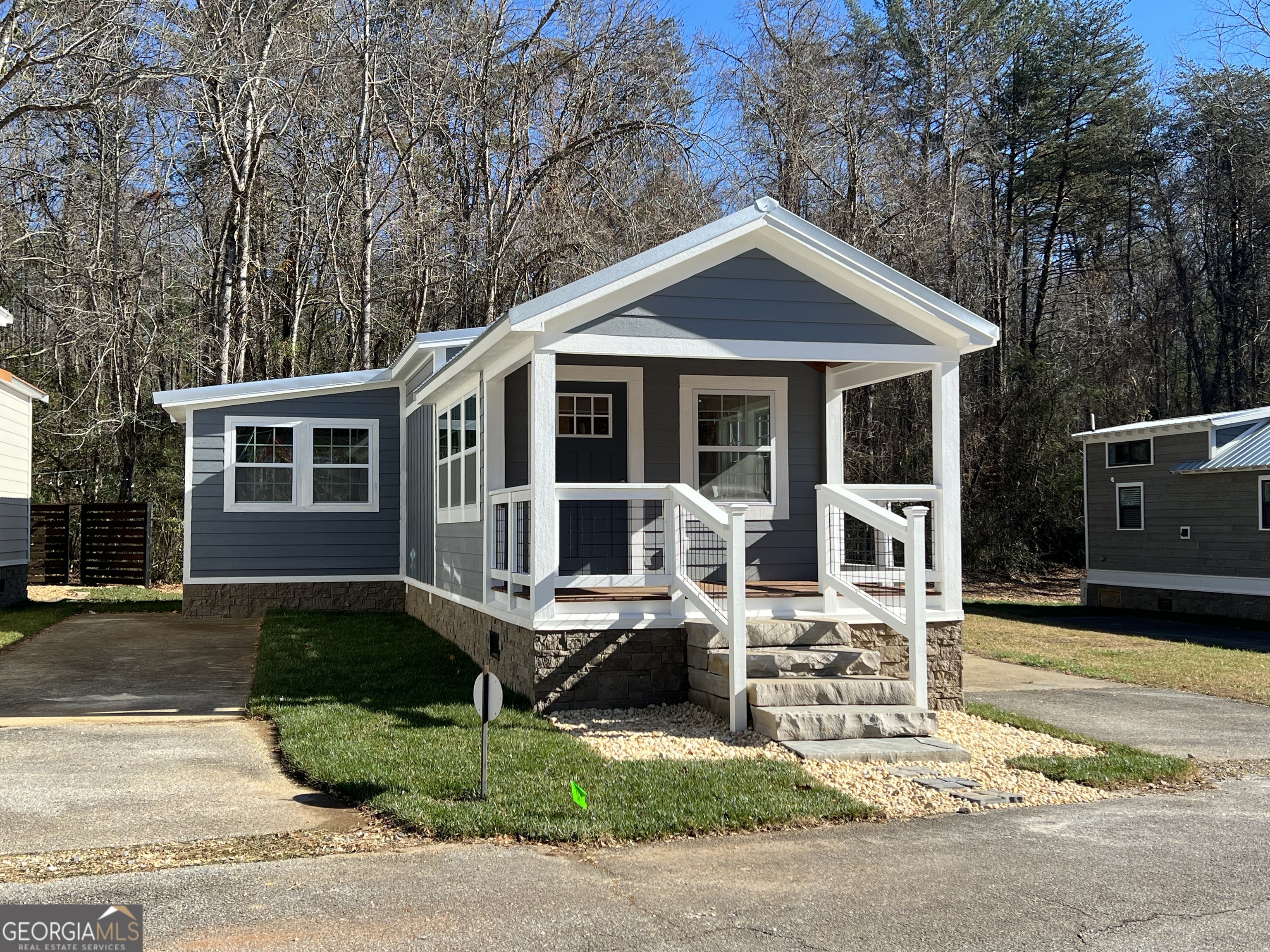 4960 Laurel Lodge Road, Unit 41 Clarkesville, GA 30523 - Photo 1 of 46 a front view of a house with garden