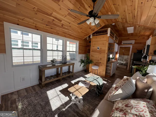 a living room with furniture and a dining table