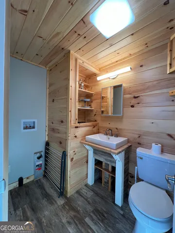 a bathroom with a sink a toilet and mirror