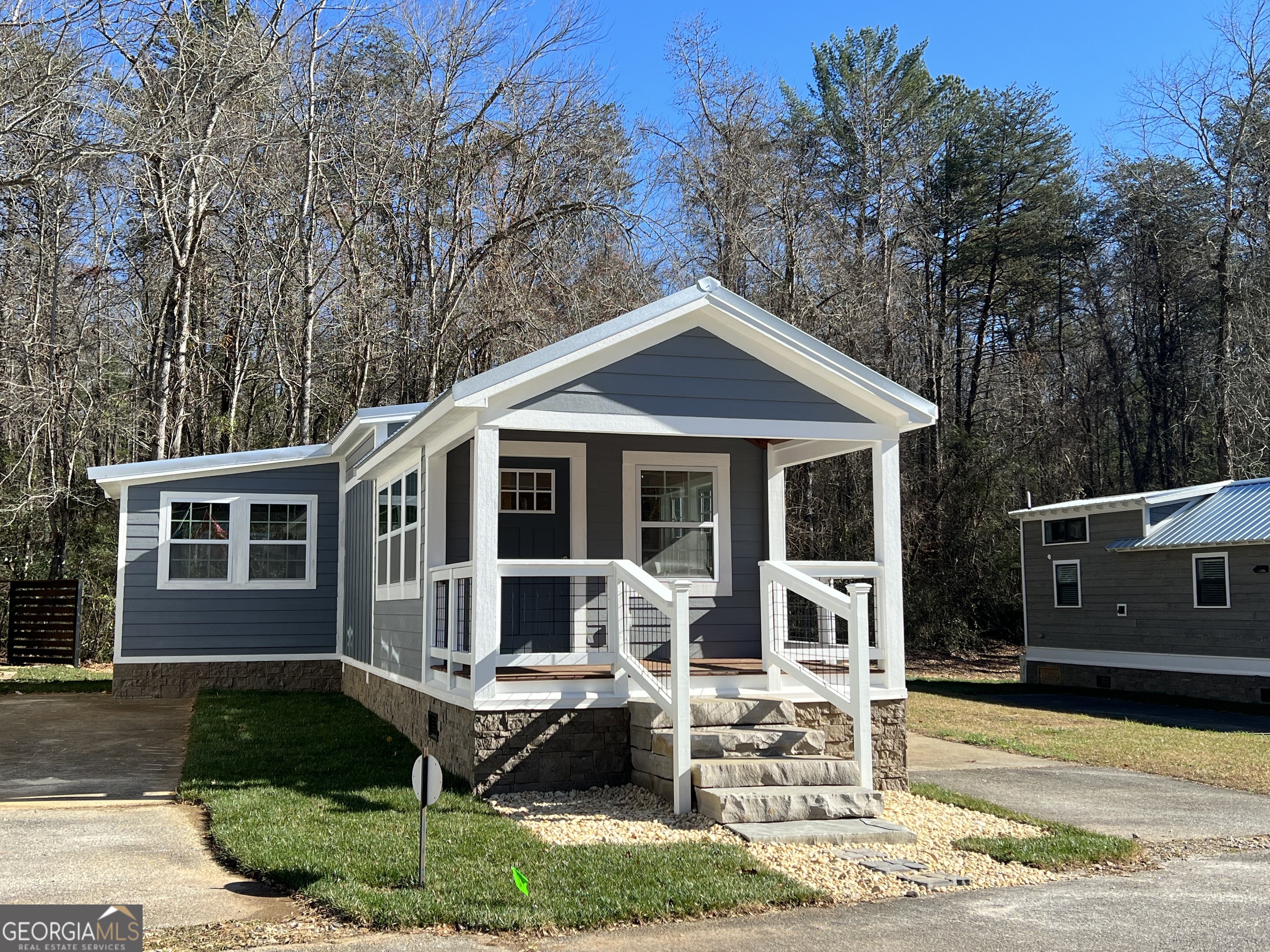 4960 Laurel Lodge Road, Unit 41 Clarkesville, GA 30523 - Photo 2 of 46 a front view of a house with garden