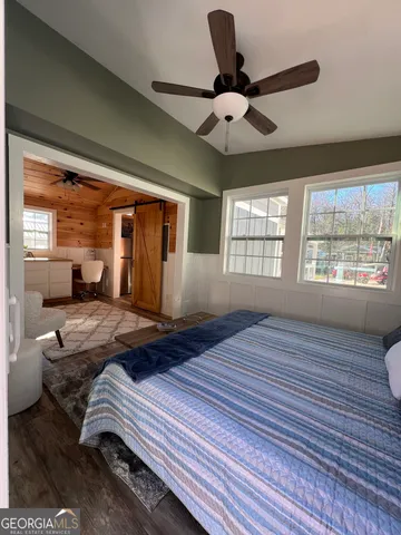 a bedroom with a bed and window