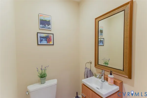 a bathroom with a sink a mirror and a toilet