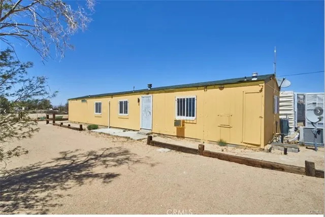 a view of a house with snow on the road