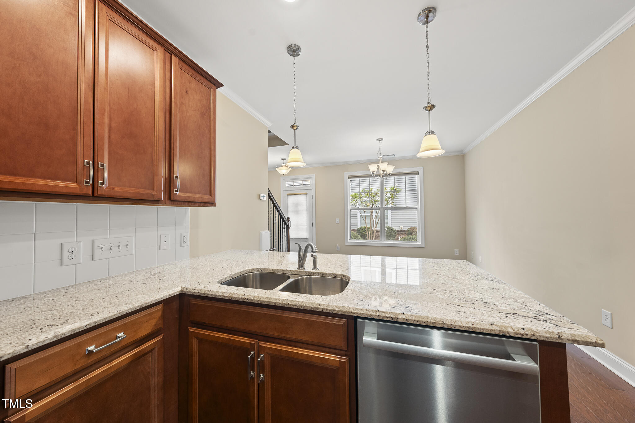 111 Wards Ridge Drive Cary, NC 27513 - Photo 11 of 46 a kitchen with stainless steel appliances granite countertop a sink and wooden cabinets
