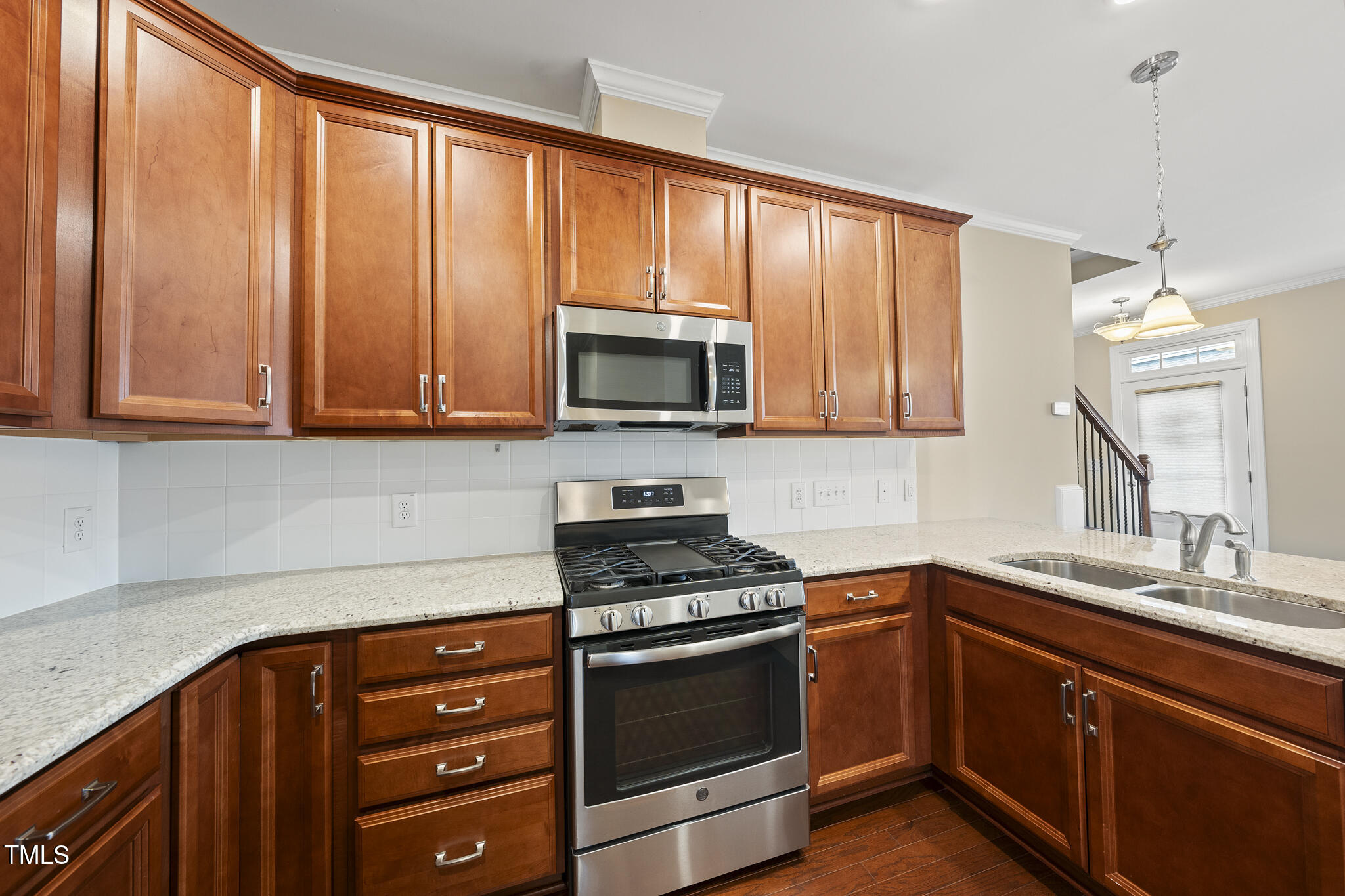 111 Wards Ridge Drive Cary, NC 27513 - Photo 12 of 46 a kitchen with granite countertop wooden cabinets and a stove top oven