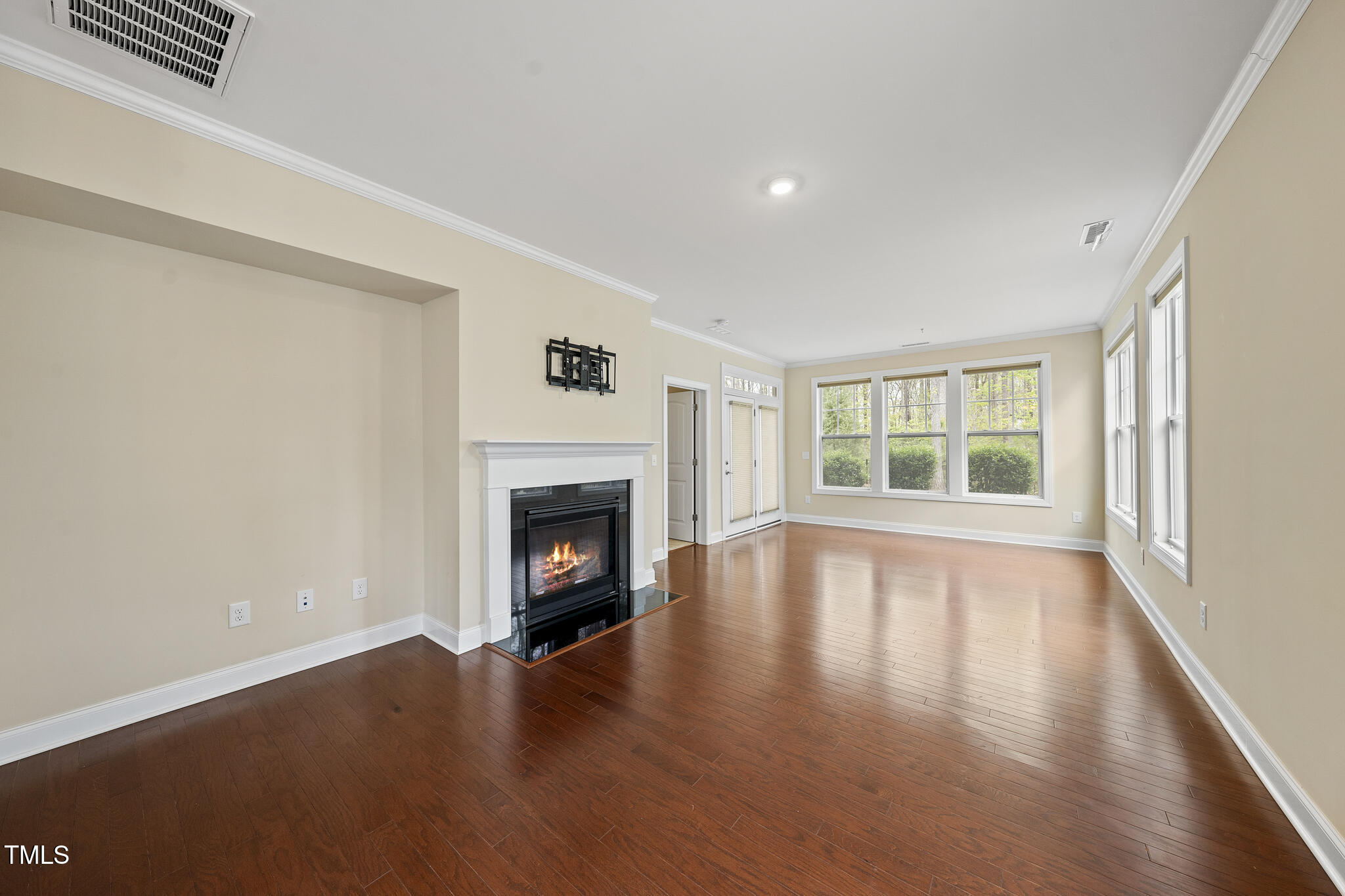 111 Wards Ridge Drive Cary, NC 27513 - Photo 15 of 46 a view of an empty room with wooden floor and a window