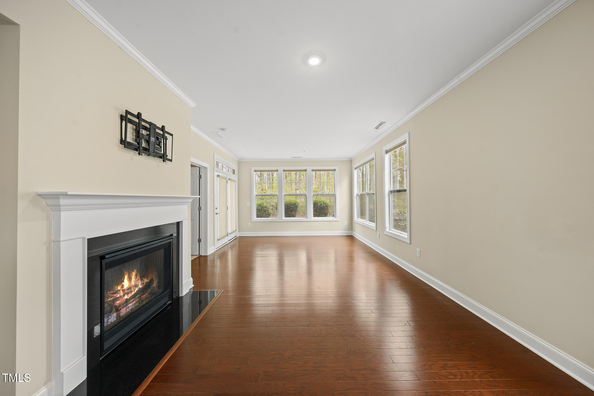 111 Wards Ridge Drive Cary, NC 27513 - Photo 17 of 46 a view of an empty room with wooden floor fireplace and a window