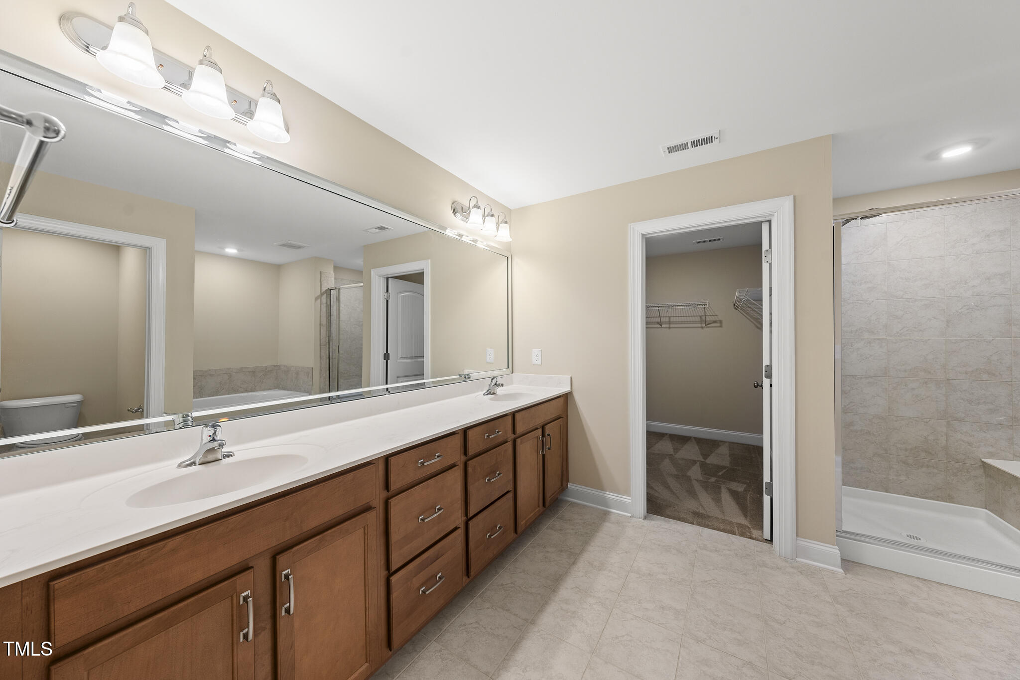 111 Wards Ridge Drive Cary, NC 27513 - Photo 29 of 46 a bathroom with double sink and a mirror