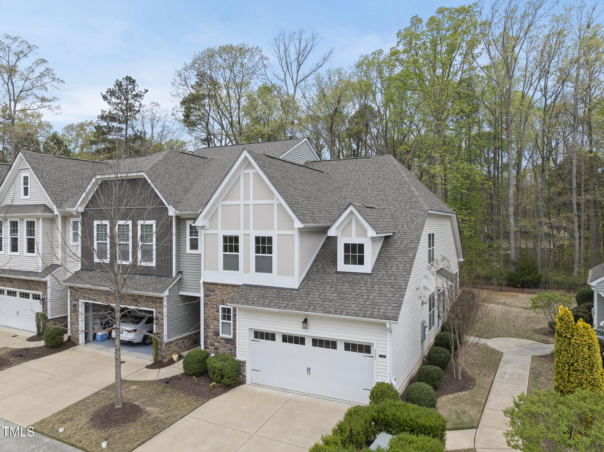111 Wards Ridge Drive Cary, NC 27513 - Photo 2 of 46 a view of a white house next to a yard with large trees