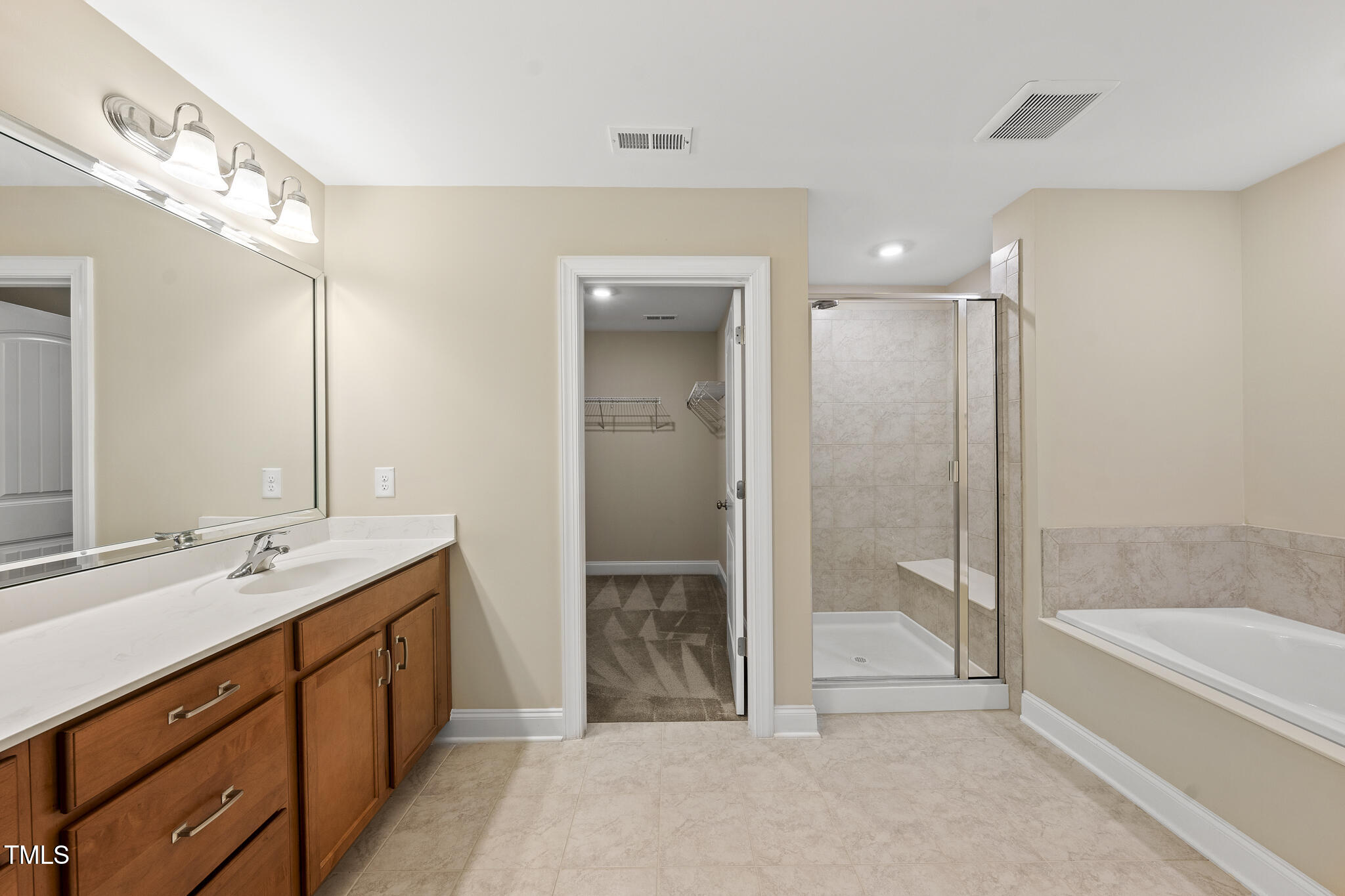 111 Wards Ridge Drive Cary, NC 27513 - Photo 30 of 46 a spacious bathroom with a tub sink shower and mirror