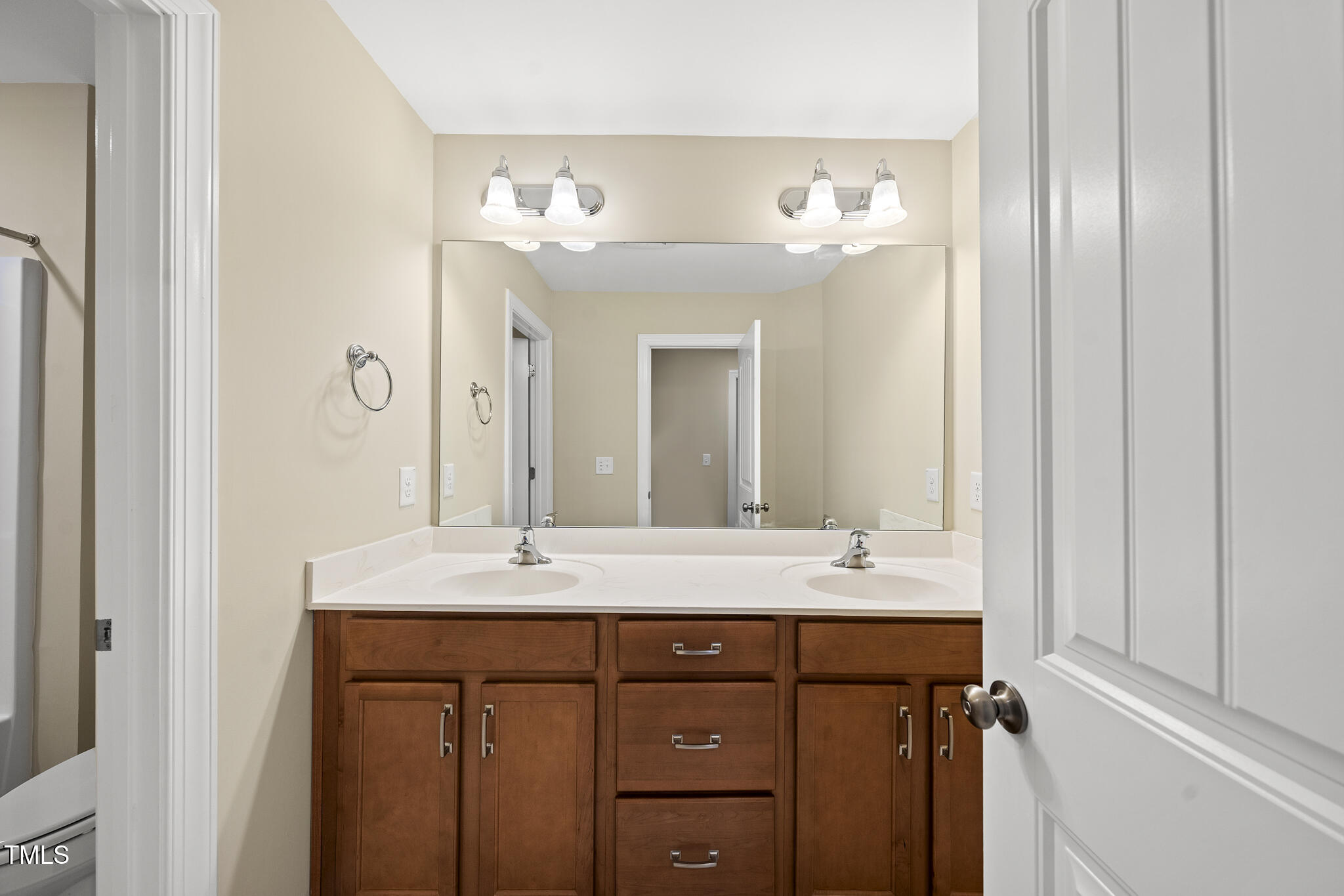 111 Wards Ridge Drive Cary, NC 27513 - Photo 38 of 46 a bathroom with a double vanity sink and a mirror