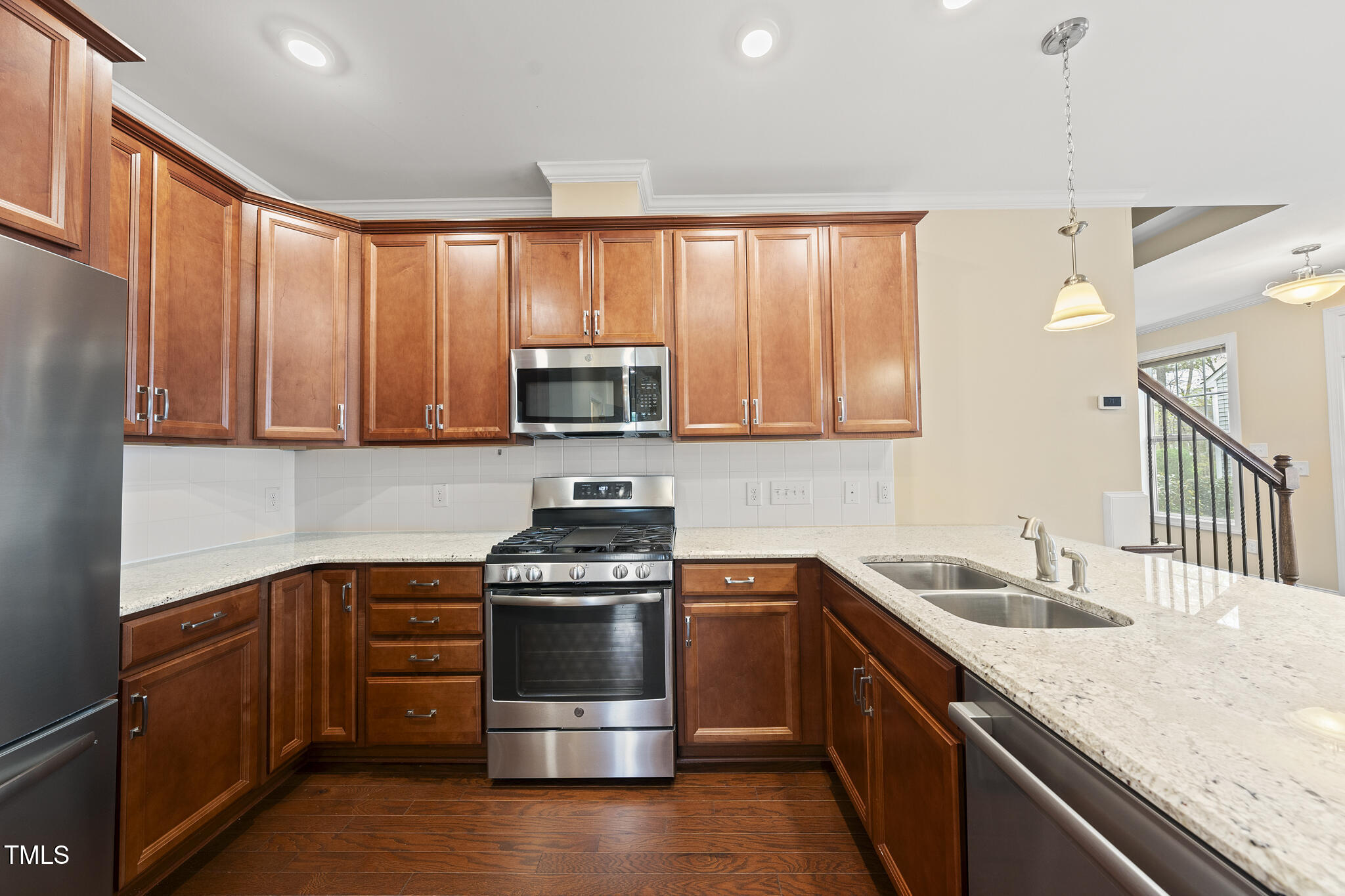 111 Wards Ridge Drive Cary, NC 27513 - Photo 9 of 46 a kitchen with stainless steel appliances granite countertop a stove a sink and a microwave