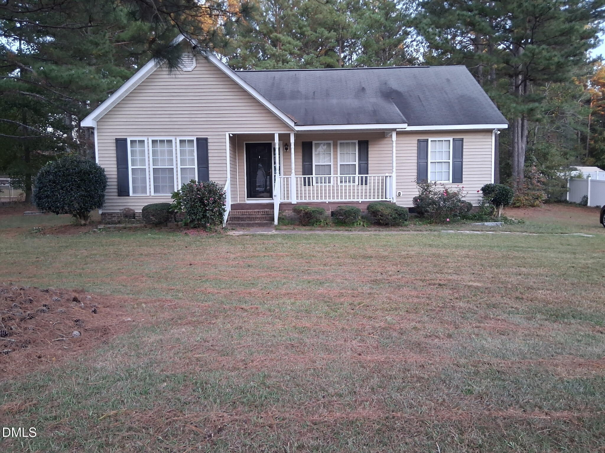 443 Tranquil Lane Willow Spring, NC 27592 - Photo 1 of 23 a view of a yard in front of a house with plants and large trees