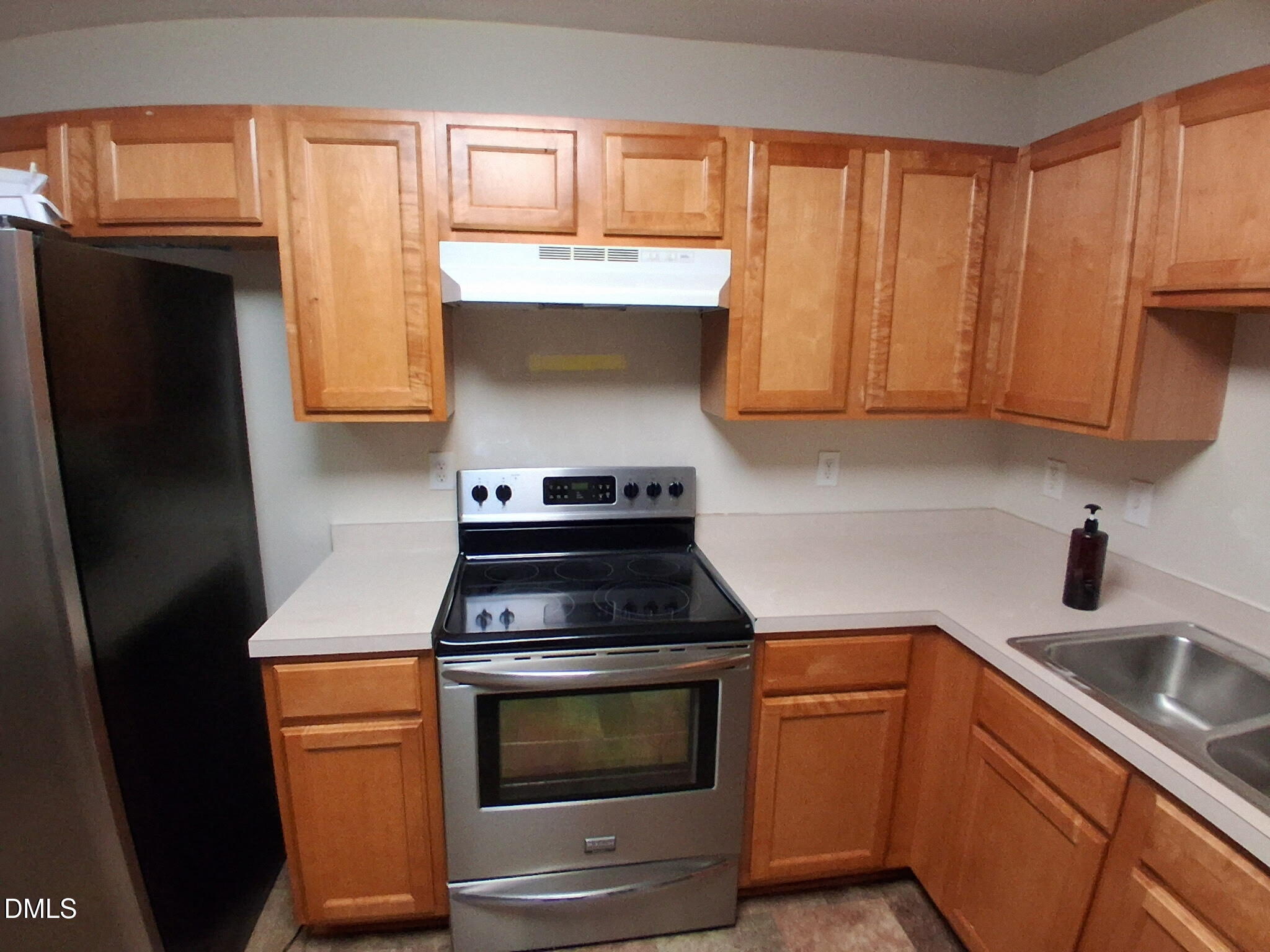 443 Tranquil Lane Willow Spring, NC 27592 - Photo 4 of 23 a kitchen with stainless steel appliances wooden cabinets and a stove top oven