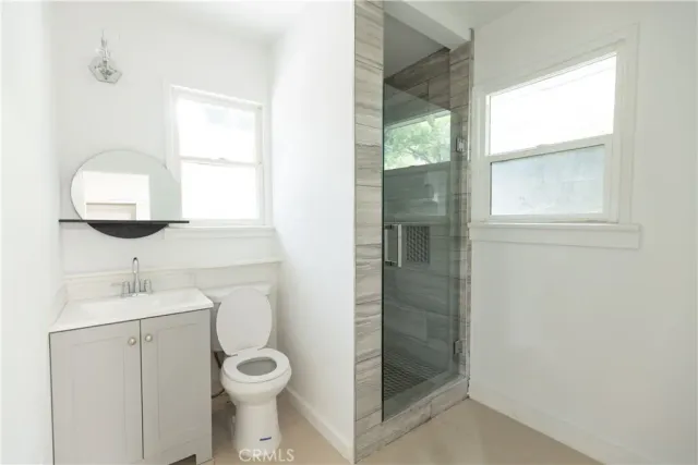 a bathroom with a toilet a sink and a window