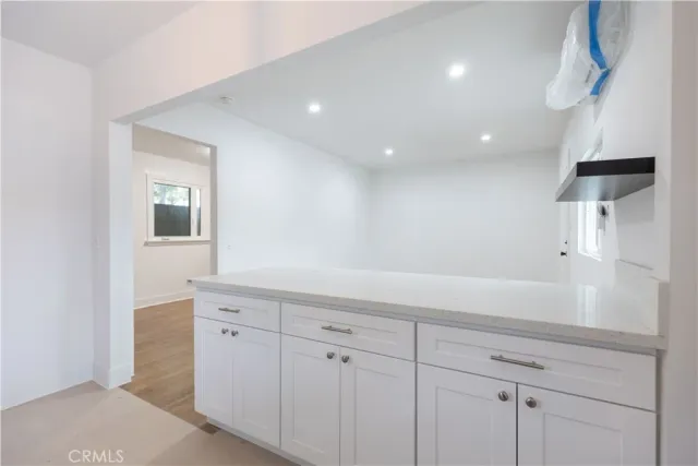 a hallway with white cabinets