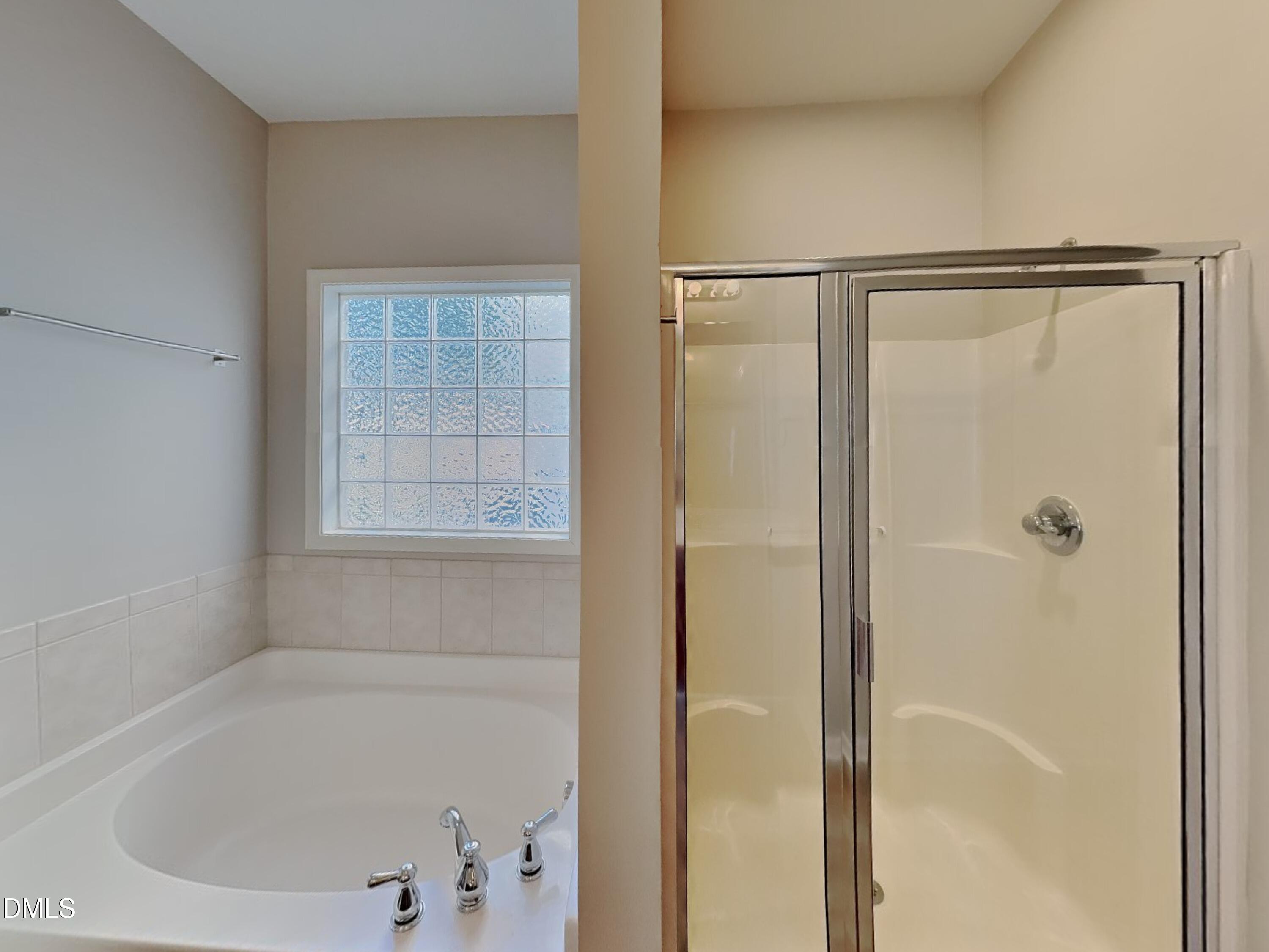 3152 Landing Falls Lane Raleigh, NC 27616 - Photo 11 of 24 a white bath tub with a shower