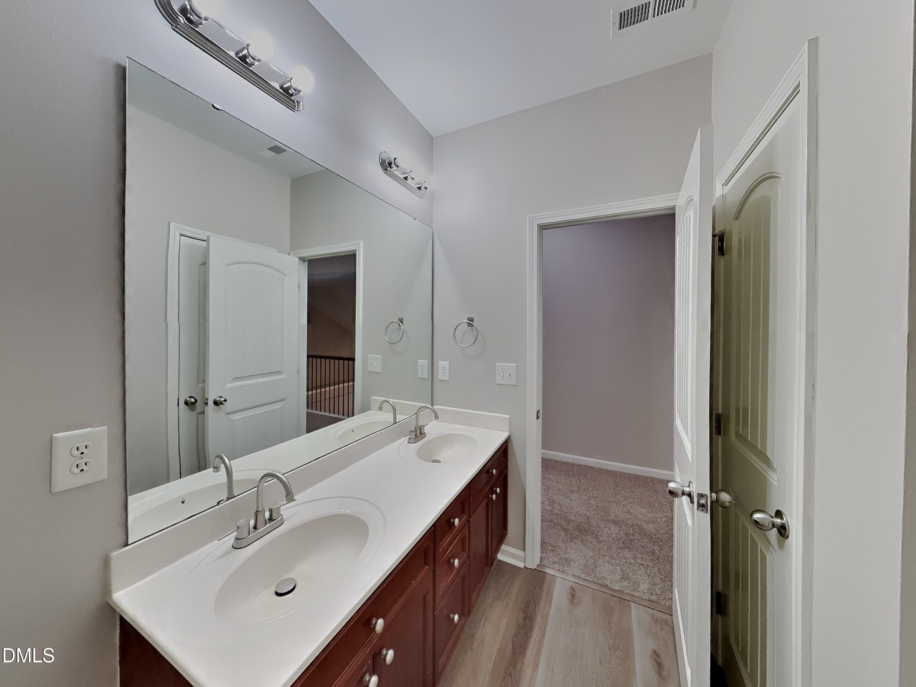3152 Landing Falls Lane Raleigh, NC 27616 - Photo 19 of 24 a bathroom with a sink double vanity and a mirror